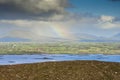 Atlantic ocean with many small islands and dramatic clouds and colorful rainbow. View from Croagh Patrick on amazing nature Royalty Free Stock Photo
