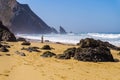 Atlantic ocean rocky coastline of Adraga beach with fisherman