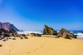 Atlantic ocean rocky coastline of Adraga beach with fisherman. Portugal Royalty Free Stock Photo