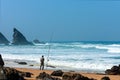 Atlantic ocean rocky coastline of Adraga beach with fisherman. Portugal Royalty Free Stock Photo