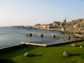 Luderitz, Namibia - Aug 3 2012: Atlantic Ocean side waterfront coast line with industrial buildings and church seen from the Royalty Free Stock Photo