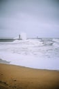 Atlantic Ocean splash time. Lighthouse. Royalty Free Stock Photo