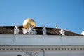 Atlas carrying golden globe - statues on the roof of Hofburg imperial palace in Vienna, Austria