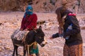 ATLAS MOUNTAINS, MOROCCO - 20 JAN: Tourist girl and Nomad tribe people living in mountains near Tinghir or Tinerhir