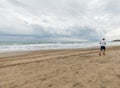 Atlethic man running on the beach Royalty Free Stock Photo