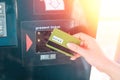 ATM and banking operations. A woman leans a Bank card in the reader at the ATM. Close up