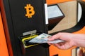 Atm bitcoin cryptocurrency machine. Woman withdraw american dollar bill cash. Usd hundred money payment on virtual