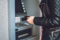 ATM cash withdrawal. Woman using ATM machine to withdraw her money. Close-up of female hand with credit card near ATM machine Royalty Free Stock Photo