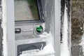 Atm machine covered with snow. Functional bank atm machine cover Royalty Free Stock Photo