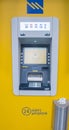 An ATM machine in a yallow balcground,in a greek town Royalty Free Stock Photo