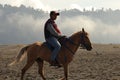 The atmosphere of the Bromo mountains in the morning, which is cold and foggy.