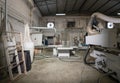 Atmosphere inside wooden furniture factory with piles of plywood and modern machinery. An exhaust fans are on lightweight concrete