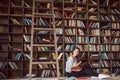 An atmosphere of passionate story reading. reading books lovely young woman. Library cozy room.