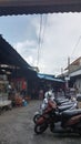The atmosphere of a traditional market is filled with motorbike parking lots and street vendors Royalty Free Stock Photo