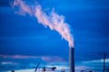 Atmospheric Air Pollution From Industrial Smoke billowing from Smoking pipes and cranes beside smoking pipes, ecology problems Royalty Free Stock Photo