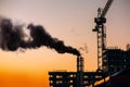 Atmospheric air pollution from industrial smoke. Crane and build Royalty Free Stock Photo