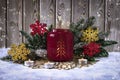 Atmospheric Christmas candle holder with fire, with fir branches, Christmas balls and decorative snowflakes