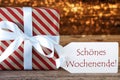 Atmospheric Christmas Gift With Label, Schoenes Wochenende Means Happy Weekend Royalty Free Stock Photo