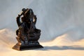 Hindu god Lord Ganesha with the head of an elephant. A statuette made of black stone