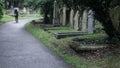 Woman walking through the rain in a graveyard