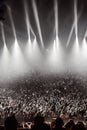 An atmospheric image of a music concert audience, featuring silhouettes of fans and misty stage lights in the background, Ai- Royalty Free Stock Photo