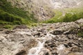 Atmospheric landscape with big stones in mountain river. Powerful water stream among boulders in mountain creek Royalty Free Stock Photo