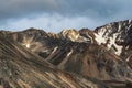 Atmospheric landscape with rocky mountain wall with pointy top in sunny light. Loose stone mountain slope in the foreground. Sharp Royalty Free Stock Photo