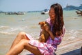 Atmospheric lifestyle candid photo of young beautiful asian woman on vacation plays with a cat.