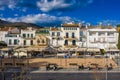 Embankment Central Street in Cadaques Spain. cozy little Cafes and restaurants in white houses. Sunny day photo. Popular