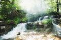 Atmospheric magical waterfall in deep wild green forest in Carpathian mountains Royalty Free Stock Photo