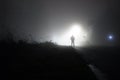 An atmospheric, moody concept. Of a man standing on a road on the edge of town, on a misty winters night. UK