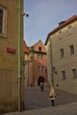 Atmospheric narrow curved street in the old district of Prague.