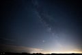 a night time picture shows the milky rising over a road