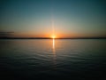 Atmospheric phenomenon sun column.Sunset over the lake. Evening summer landscape.Horizontal photo