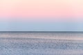 Atmospheric romantic pink red sea sunset sky above blue quiet water, minimalistic peaceful seascape