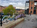 Atmospheric scene of a parked bicycle at the restored Victorian canal system in Castlefield area of Manchester