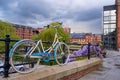 Atmospheric scene of a parked bicycle at the restored Victorian canal system in Castlefield area of Manchester