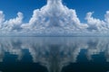 Atmospheric sky art image. White Cumulonimbus cloud in blue sky with ocean water reflections. Australia