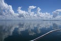 Atmospheric sky art image. White Cumulonimbus cloud in blue sky with ocean water reflections. Australia