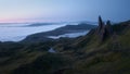 Atmospheric top view of the high sharp cliffs towering over the lakes and the sea covered with low clouds before dawn