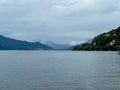 Atmospheric View from Cannobio Across Lake Maggiore Toward the Misty Hills of Luino, Verbano-Cusio-Ossola, Piedmont, Italy Royalty Free Stock Photo
