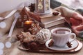 Atmospheric winter coziness at windowsill at snowy day. Aesthetic Christmas home with books, gingerbread cookies