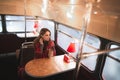 Atmospheric winter portrait of the girl is covered in a blanket,sits in a cozy cafe with a retro interior