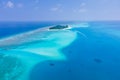 Atoll island with white sand beach, turquoise transparent water, coral reef, blue sky. Perfect tropical vacation holidays Royalty Free Stock Photo