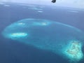 Atolls of the Maldives outside of a plane window