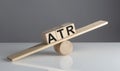 ATR on wooden cubes on wooden balance , business concept