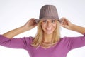 Atractive blonde woman with hat in violet sweater