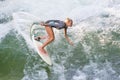 Atractive sporty girl in neoprene shorty wave surfing.