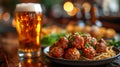 an atractive and tastefull image of meatballs portion and pint of beer together