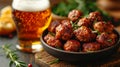 an atractive and tastefull image of meatballs portion and pint of beer together